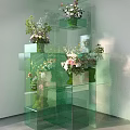 Creative Art Installation With Stacked Green Transparent Cubes And Flower Decorations