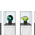 Decorative Ornament Set with Various Colors and Shapes in Glass Display Cases on Marble Bases
