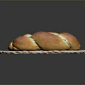 Freshly Baked Golden Brown Braided Bread On Woven Mat Ready For Serving