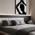 Modern Double Bed With Soft Headboard Gray Bedding Nightstand Books And Black White Wall Art