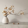 Elegant Bonsai Plant Arrangement With White Vase Golden Flowering Branches On Marble Countertop And Walnuts