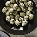 Quail Eggs Arranged On Plates With Greenery