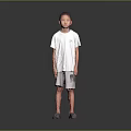 Young boy standing wearing white T-shirt gray shorts and gray shoes on gray gradient background