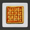Golden Square Waffles Stacked On White Plate With Crispy Texture And Homemade Style