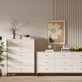 White Dressers With Multiple Drawers In Room With Green Plant Decorative Painting And Wooden Floor