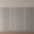 Three White Grid Patterned Room Dividers Standing on Light Wooden Floor Against Neutral Wall