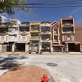 Row of Terraced Townhouses with Colorful Facades Balconies and Urban Street View