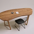 Wooden Oval Shaped Desk With Black Object Notebook And Metal Frame Chair