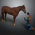 Woman Kneeling On Ground Reaching Out To Brown Horse In Blue Outfit And Hat
