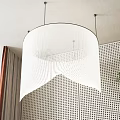 Modern Pendant Light With White Pleated Design In Interior Space Against Perforated Wall And Plant