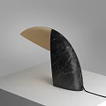 Modern Curved Table Lamp With Black Marble And Beige Accents On White Surface
