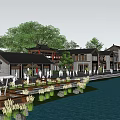 Traditional Style Commercial Street Along Waterfront With Nighttime Lighting And Pedestrian Activity