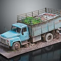 Old Blue Truck With Worn Body Loaded Green Plants On Gravel Ground