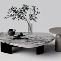 Marble Coffee Table With Glass Vase Green Branches Stacked Plates And Gray Round Side Table