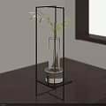 Modern Black Metal Frame Side Table with Clear Glass Vase and Green Plant