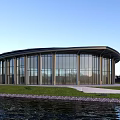 Modern Circular Glass Building Exterior With Scenic Waterfront And Green Grass