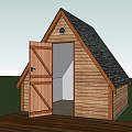 Wooden Hotel Building Featuring Gabled Roof Black Shingles Open Door Small Window Green Grass Deck