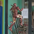 Iron Man Floating In Lab Environment With Glowing Armor And Tech Elements