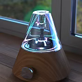 Modern Electronic Device With Transparent Cone Design Wooden Base Black Components And Colorful Light Effects