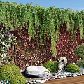 Lush Living Plant Wall with Hanging Greenery Colorful Foliage Stone Statue Pebbles and Wooden Floor
