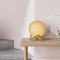 Yellow Globe Table Lamp with Wooden Stand on Wooden Table White Wall and Wall Art