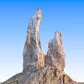 Outdoor Scenery with Towering Stone and Wood Natural Structures Under Blue Sky