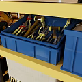 Yellow Display Shelves With Tools Cans And Boxes Against Blue Wall Background 3d model