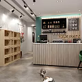 Modern Café Interior With Wooden Counter Green Chair Shelves And Cat