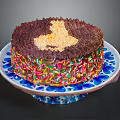 Chocolate Cake With Golden Cream Topping And Colorful Sprinkles On Blue And White Plate