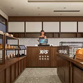 Cozy Dessert Shop Interior Featuring Wooden Counter Fresh Pastries And Bread On Shelves
