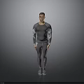 Man Wearing Gray Long Sleeve Top and Pants Standing in Studio with Gray Background
