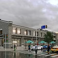 Vibrant Commercial Street With Gray Brick Buildings Pedestrians Green Umbrellas Traffic Lights And Wet Road
