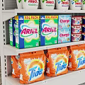 White Retail Display Shelf In Supermarket Stocked With Various Cleaning Products