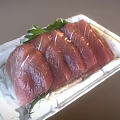 Fresh Raw Tuna Slices Arranged On White Tray With Green Garnish