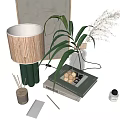 Decorative Ornament Set With Woven Shade Lamp Green Plant And Glass Vase On Books