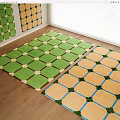 Two Colorful Patterned Rugs In Bright Room With Wooden Floor