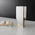 Unique-shaped Table Lamp with Open Book on Light-colored Countertop and Dark Wooden Texture Wall
