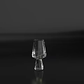 Transparent Glass Wine Glass With Slender Body And Wide Base On Black Tabletop