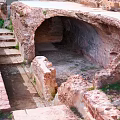 Cartoon Scene of Ancient Ruins with Stone Archway Stone Steps and Old Stone Structures