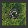 Scenic Miniature Landscape Featuring Ancient Stone Tower Surrounded by Lush Green Grass and Small Trees