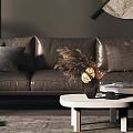 Modern Three-Seater Sofa with Large Window Natural Light Round Art Coffee Table and Green Plants