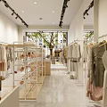 Bright Minimalist Clothing Store With Hanging Clothes Display Table Mannequins Sofa And Shoes