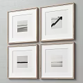 Four Black And White Framed Artworks Hanging On Minimalist Wall Decor