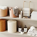 Neatly Stacked Towels In Bathroom With Storage Baskets And Toiletries