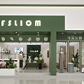 Modern Green Facade Clothing Store With Mannequins Window Displays And Lighting