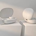Wireless Headphones with Black and White Charging Cases on Display Stand