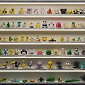 Assorted Stuffed Animal Dolls Neatly Arranged On Multiple Shelves With Colorful Designs