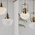 Brass and White Glass Pendant Lights in Modern Interior with Green Plants and Window Blinds
