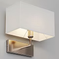 Modern Wall Lamp With White Lampshade And Metal Base On Gray Wall Emitting Warm Light