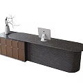 Modern Reception Desk With Dark Stone Countertop Brown Cabinets White Vase Twigs And Computer Monitor